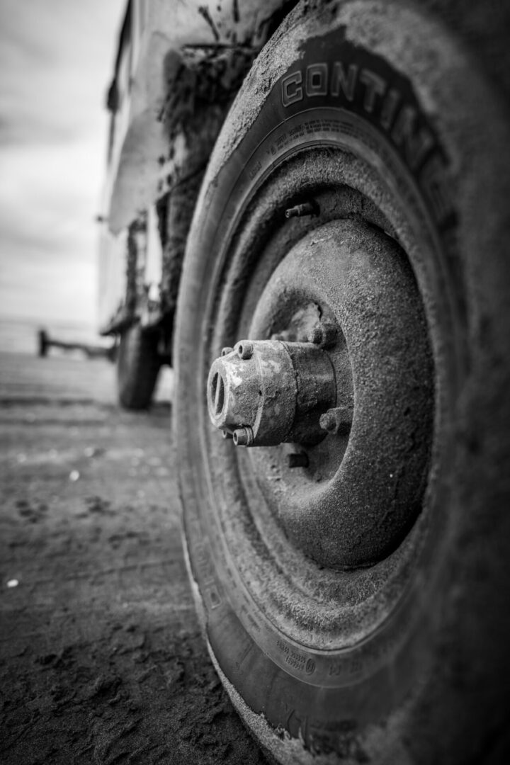 A close up of the tire on an old truck.