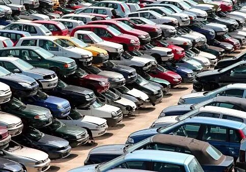 A lot of cars parked in a parking lot.